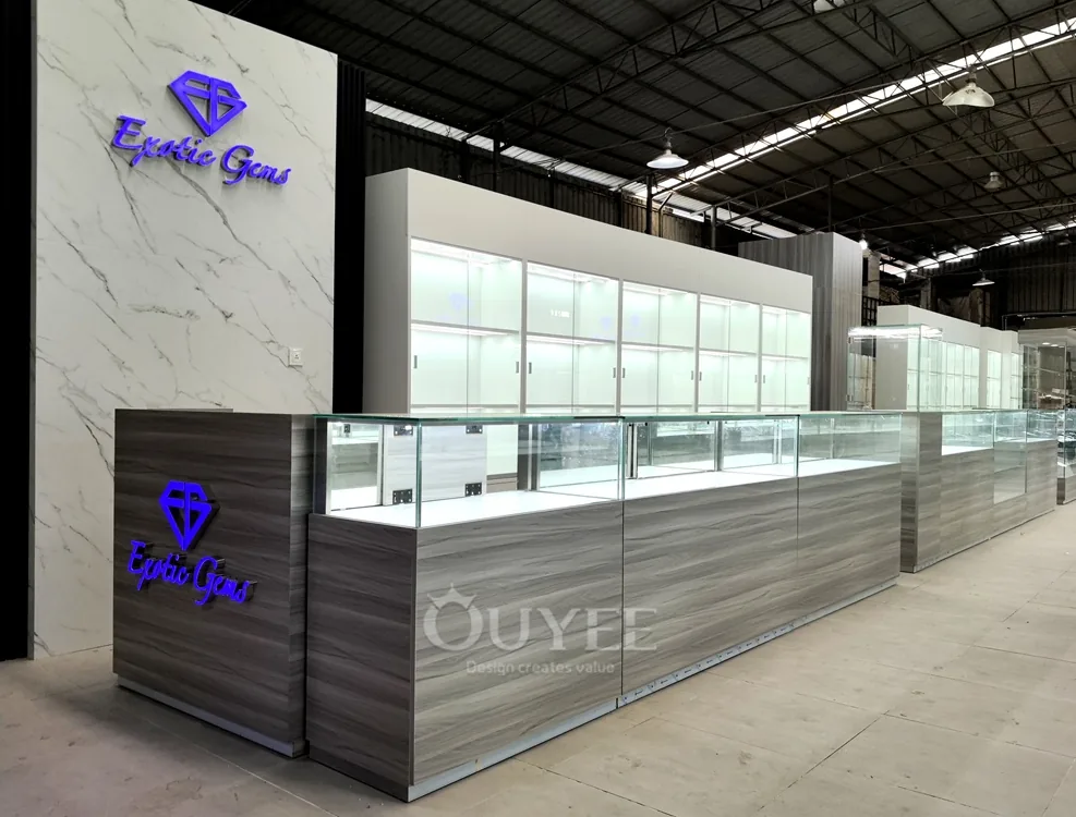 Long Gray Jewelry Showcase Counter with Marble Branding Wall 04