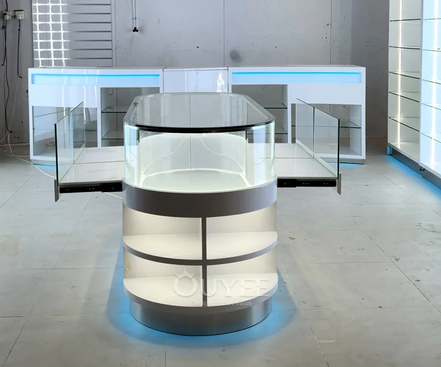 White Oval Glass Showcase Island with Backlit Wall Shelves 02